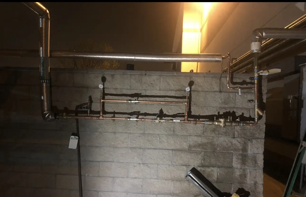 Commercial copper piping assembly with valves and pressure-test gauges