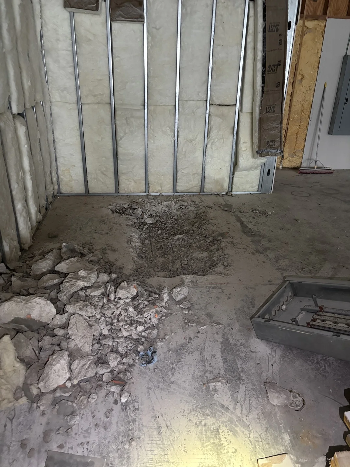Concrete slab opened for a commercial plumbing project before underground work