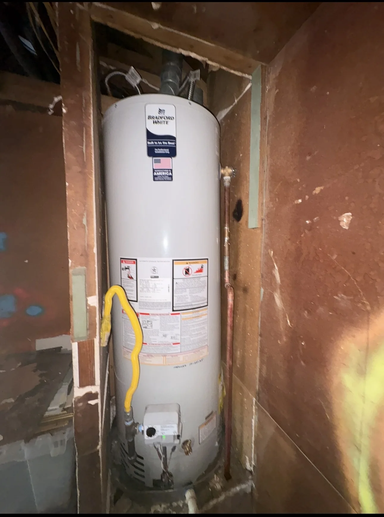 Bradford White gas tank water heater installed in a residential utility space